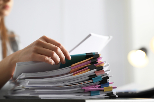 Person looking at a stack of Documents