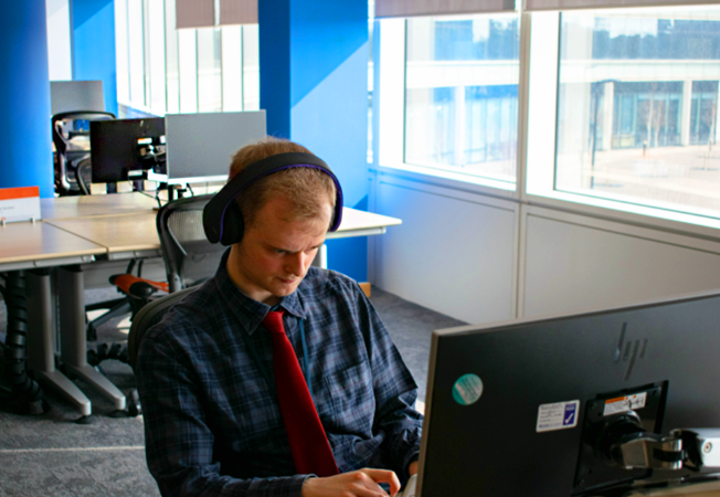 George Goodlake sitting at a computer, working 